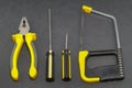 A set of tools on a gray background pliers, screwdriver Royalty Free Stock Photo