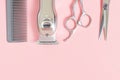 A set of tools for hairdresser, scissors, comb on pink background, copy space. Royalty Free Stock Photo
