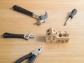 Set of tools and handmade wood house toy. Royalty Free Stock Photo