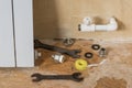 A set of tools and materials for repair near a leaking radiator. Accident of the heating system of a private house