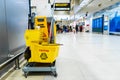 A set of tools and plates for mopping at the airport. Yellow bucket plates and brushes. Cleaning Service