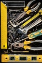 Tools, screws and nuts on a metallic background