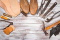 Set of tools for shoemaker on white wooden background. Copy space. Royalty Free Stock Photo