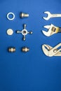 Set of tools and spare parts for plumbing isolated on blue background Royalty Free Stock Photo