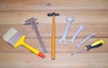 Wide brush, caliper, small hammer, wrenches, screwdriver - set of tools on a wooden background: Royalty Free Stock Photo