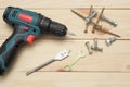 set of tools on wooden table, a electric screwdriver with a set of drill bits and screws with bolts. work tool on wooden Royalty Free Stock Photo