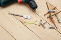 set of tools on wooden table, a electric screwdriver with a set of drill bits and screws with bolts. work tool on wooden Royalty Free Stock Photo