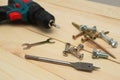 set of tools on wooden table, a electric screwdriver with a set of drill bits and screws with bolts. work tool on wooden Royalty Free Stock Photo