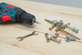 set of tools on wooden table, a electric screwdriver with a set of drill bits and screws with bolts. work tool on wooden Royalty Free Stock Photo