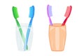 Set of toothbrushes in a glass isolated on white background. Pair of toothbrushes in a cup.
