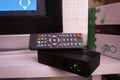 Set-top box for receiving video and TV signal. Remote control. Details and close-up.