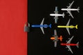 Set of toy planes next to a padlock on a black and red background. The concept of a no-fly zone, sanctions and an air embargo. Non