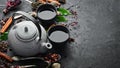 Set traditional Chinese tea on black stone background. Tea in teapot and cup. Top view. Royalty Free Stock Photo