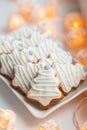 Set of traditional decorated Christmas tree shaped gingerbread cookies on the plate