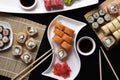 Set of traditional japanese food on a dark background. Sushi rolls, nigiri, raw salmon steak, rice, cream cheese Royalty Free Stock Photo
