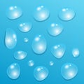 Set of  transparent  drops of pure clear water isolated on a blue background Royalty Free Stock Photo