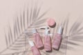 Set of travel size pink cosmetic bottles out clear bag. Mock up bodycare products for vacation or journey.