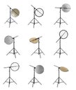 Set of tripods with different reflectors on white background. Professional photographer`s equipment