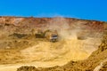 Trucks and the excavator work in career at mining