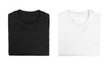 Set of two black and white folded t-shirts isolated on white background