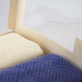 A set of two cotton terry towels in a paper box on a light background Royalty Free Stock Photo