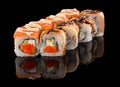 Set of Two different Sushi roll with salmon, cheese, cucumber, tobiko caviar, eel, sauce and sesame isolated on black Royalty Free Stock Photo