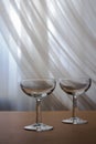 Set of two empty transparent glasses for drinks isolated on brown textured background with abstract reflection effect with shadows Royalty Free Stock Photo