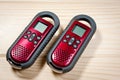 Set of two intercoms of red color on a wooden background