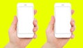 Set two phones with empty blank display isolated on yellow background, male hands hold phones vertical, 2 smart phones Royalty Free Stock Photo