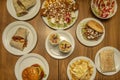 Set of typical kebab restaurant dishes with falafel, french fries, burger, kebab meat and other things on a wooden table