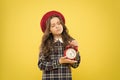 Set up alarm clock. Child little girl hold red clock. It is time. Always on time. It is never too late. Define your own