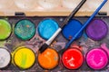 A set of used watercolor paints with brushes close-up Royalty Free Stock Photo