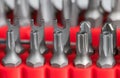 Closeup of steel secure torx or pozidrive screwing bits in red plastic holder