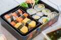 variety sushi, Tamagoyaki, crabsticks sushi and maki in bento box served with soy sauce and wasabi. Delicious japanese food Royalty Free Stock Photo