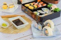 variety sushi, Tamagoyaki, crabsticks sushi and maki in bento box served with soy sauce and wasabi. Delicious japanese food Royalty Free Stock Photo