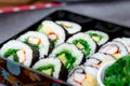 Set of variety sushi, Tamagoyaki, crabsticks sushi and maki in bento box served with soy sauce and wasabi. Delicious japanese food Royalty Free Stock Photo