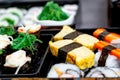 Set of variety sushi, Tamagoyaki, crabsticks sushi and maki in bento box served with soy sauce and wasabi. Delicious japanese food Royalty Free Stock Photo