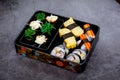 Set of variety sushi, Tamagoyaki, crabsticks sushi and maki in bento box served with soy sauce and wasabi. Delicious japanese food Royalty Free Stock Photo