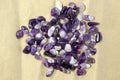 Set of various amethyst natural mineral stones and gemstones on craftpaper Narrow focus line, shallow depth of field