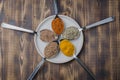 Set of various aromatic colorful spices in spoons on a in a bowl on a wooden table. Top view