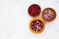 Set of various dried kidney legumes beans in wooden bowls