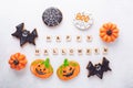 Set of various gingerbread cookies and Happy Halloween wooden blocks on white background. Bright homemade cookies for Royalty Free Stock Photo