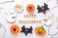 Set of various gingerbread cookies and Happy Halloween wooden blocks on white background. Bright homemade cookies for Royalty Free Stock Photo