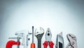 Set of various hand tools on grey background top view including different kinds of wrenches, pliers, clamps, calipers Royalty Free Stock Photo