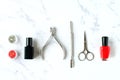 Set of various manicure and pedicure tools and accessories on white marble background. Top view Royalty Free Stock Photo