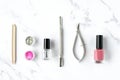 Set of various manicure and pedicure tools and accessories on white marble background. Royalty Free Stock Photo