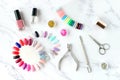 Set of various manicure and pedicure tools and accessories on white marble background. Royalty Free Stock Photo