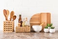 A set of various modern kitchen utensils on a marble countertop against a white brick wall. eco-friendly materials without plastic Royalty Free Stock Photo