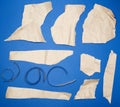 Set of various pieces of torn brown crumpled paper on a blue background