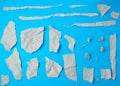 Set of various pieces of torn gray crumpled paper on a blue background